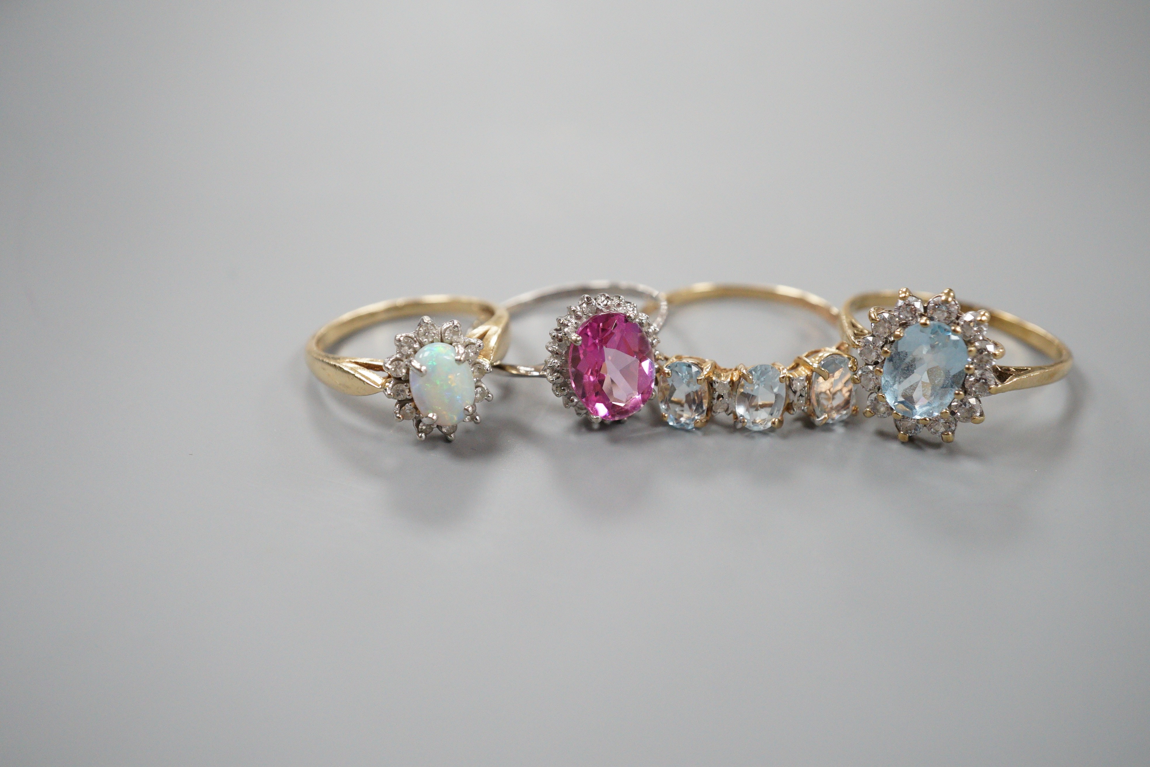 A modern 9ct gold, sapphire and diamond oval cluster set bar brooch, 34mm, gross weight 2.4 grams, a modern 9ct gold and gem set oval cluster ring, gross 2.2 grams, two modern 10k and gem set dress rings, gross weight 3
